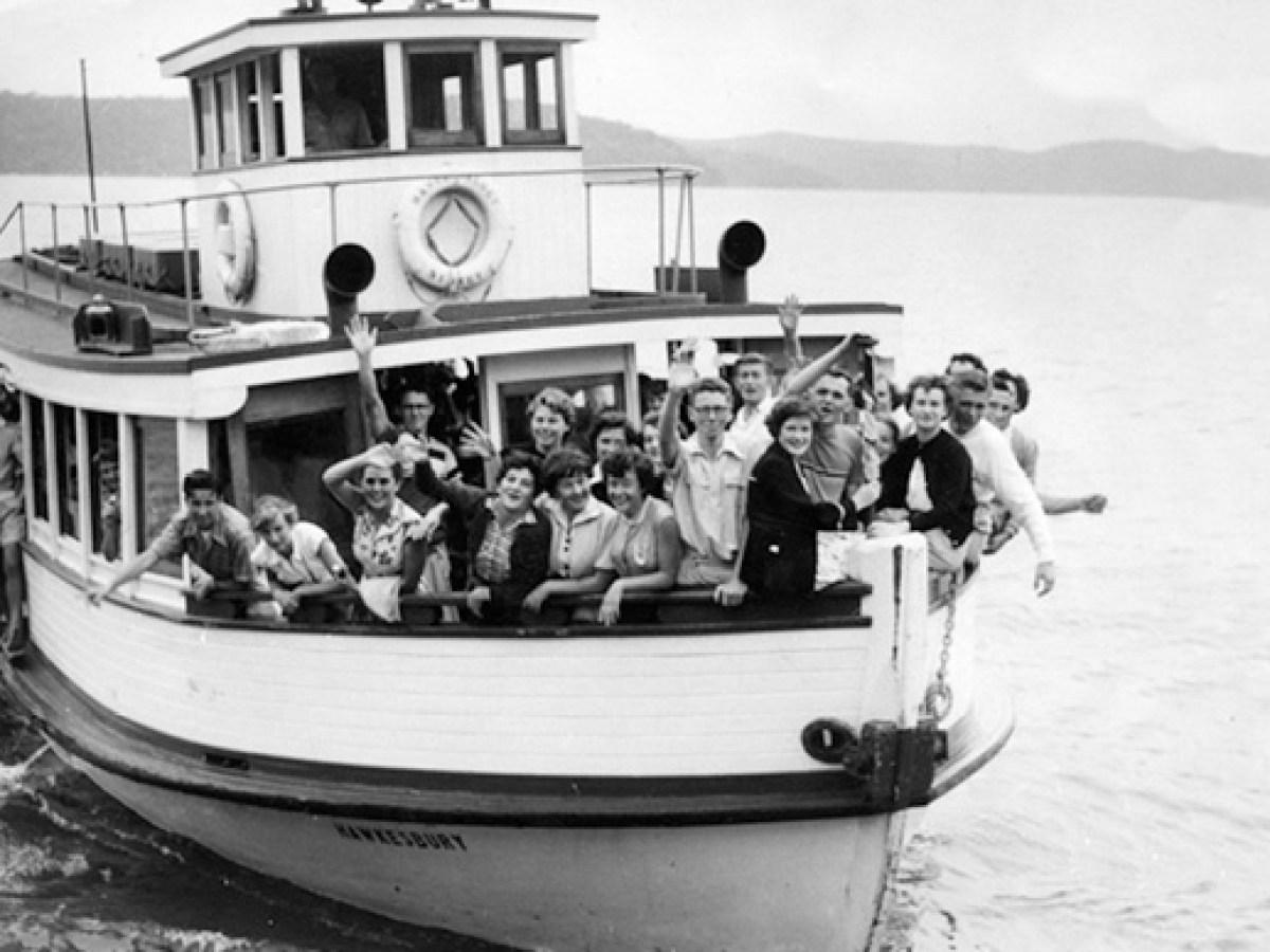 a group of people in a small boat in a body of water