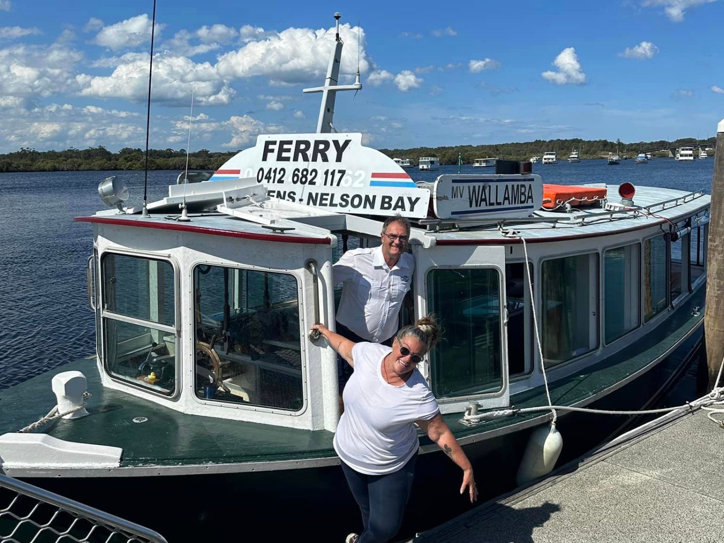 a man standing next to a boat